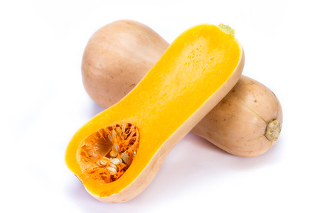 organic butternut squash cut in half isolated on a white backgroundの写真素材