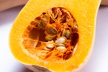 organic butternut squash cut in half isolated on a white backgroundの写真素材
