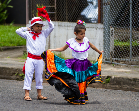 Young children celebrating independence day in Costa Rica with traditional clothing and dancing.のeditorial素材