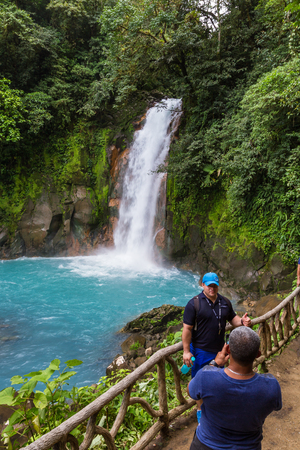 Tenorio National Park, Costa Rica - September 24 : Vistiros enjoying he beautful view of the waterfall and turqouise river. September 24 2017, Tenorio National Park Costa Rica.のeditorial素材