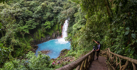 Tenorio National Park, Costa Rica - September 24 : Tour guide waiting for his group as they enjoy the waterfall at the base of the trail. September 24 2017, Tenorio National Park Costa Rica.のeditorial素材