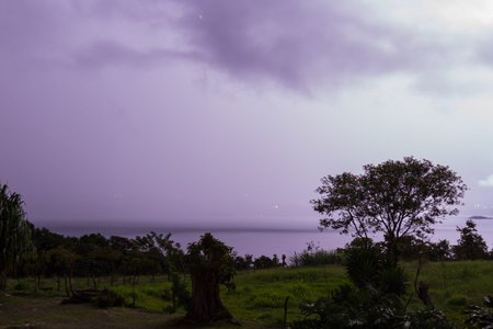 beautiful purple clouds with bright spots on a dark night from lighting hitting cloud to cloud over...