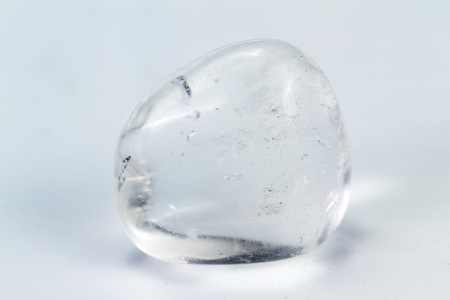 Close up of a polished piece of clear quartz isolated on a white backgroundの写真素材