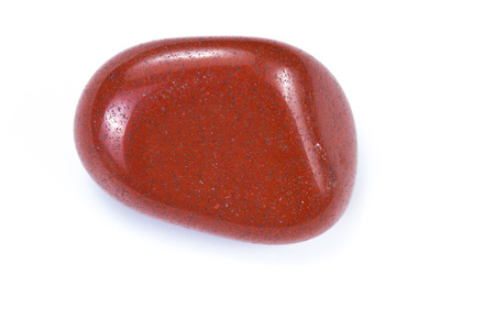 Close up of a piece of polished red jasper isolated on a white backgroundの写真素材