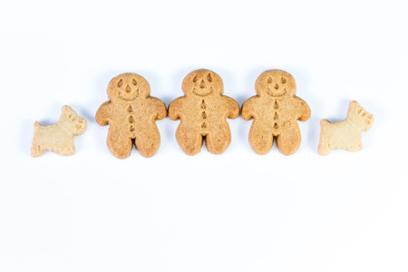 group of gingerbread man standing together with their scotty dog on a white backgroundの写真素材