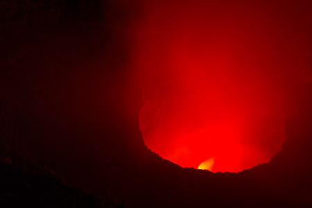 night time shot of the glowing red steam being let out into the air from this Volcano near Managua, Nicaraguaの写真素材