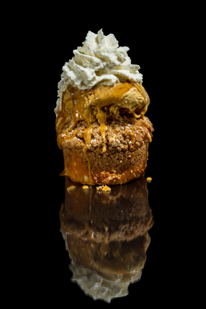 layered dessert consisting of an apple cake topped with salted caramel ice cream and a dollop of whipped creamの写真素材