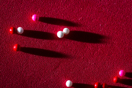 macro of a group of small edible sugar sprinkles with long shadows as a conceptual backgroundの写真素材