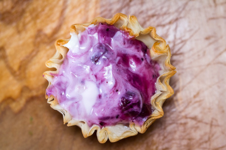 baked phyllo dough cups filled with a fresh berry and yogurt mixture as a sweet treatの写真素材