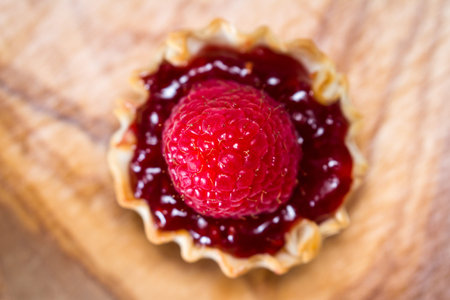 baked phyllo dough filled with a fruit jam topped with a fresh raspberry
