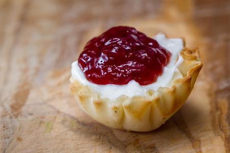 baked phyllo dough cups filled with berry jam and yogurt  as a sweet treatの写真素材
