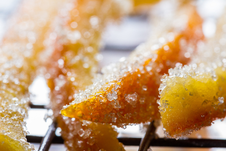 macro image of home made candied orange peel with large sugar granulesの写真素材