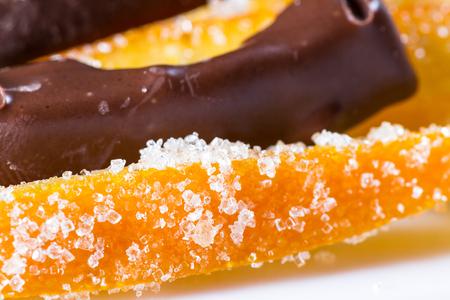macro image of home made candied orange peel some pieces dipped in chocolateの写真素材