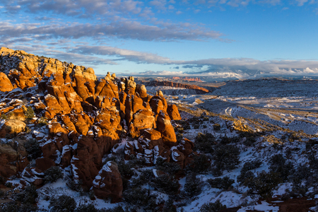 colorful feature known as the Fiery Furnace in Arches National park, partially lit up by the setting sun leaving the rock with a red glowの写真素材