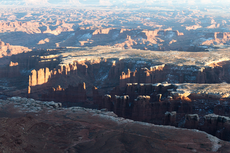 Canyon inside of a larger canyon in Canyonlands NP as the sun sets and glows on the red rocksの写真素材