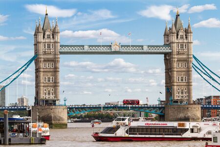 London  - September 05 2019: Iconic Double decker crossing the Tower Bridge with a water Taxi coming in for passengers, London September 05,  2019のeditorial素材