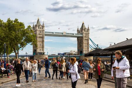 London  - September 05 2019: Iconic Double decker crossing the Tower Bridge with a water Taxi coming in for passengers, London September 05,  2019のeditorial素材