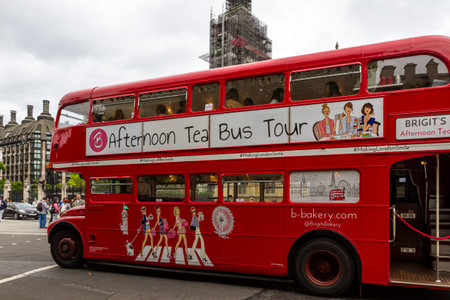 London  - September 06 2019: Iconic double decker bus touring Westminster with Big Ben in the Background, London September 06,  2019のeditorial素材