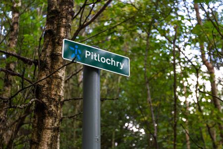 Footpath signs in the Scottish highlands marking direction to the town of Pitlochryの写真素材