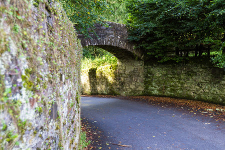 Moss covered stone walls and an arch entering the Blair Castle grounds from the General Wade's Military road in the Scottish Highlandsの写真素材