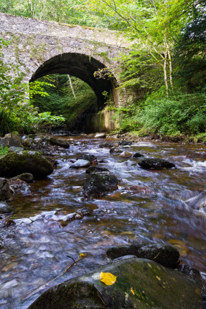 Banvie Bridge near Pitlochry in the Scottish Highlands as the fresh water water runs downstream over...