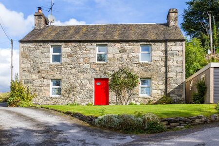 Pitlochry Scotland  - September 10 2019: Red door on the old Post Office, now uses as a holiday cottage, UK September 10,  2019のeditorial素材