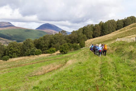 Pitlochry Scotland  - September 10 2019: Group of tourists walking gin the Scottish Highlands, UK...