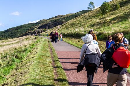 Edinburgh Scotland  - September 13 2019: People walking towards Arthur's seat the summit of the mountain in Holyrood Park, Edinburgh UK September 13,  2019のeditorial素材