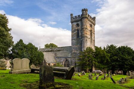 Culross, Scotland  - September 16 2019: Headstones in the Cemetery with Culross Abbey in the background in Dunfermline, Fife UK September 16,  2019のeditorial素材