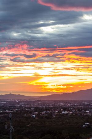 clear view of the coast across the central valley in Costa Rica with beautiful sunset colors in the cloudsの写真素材