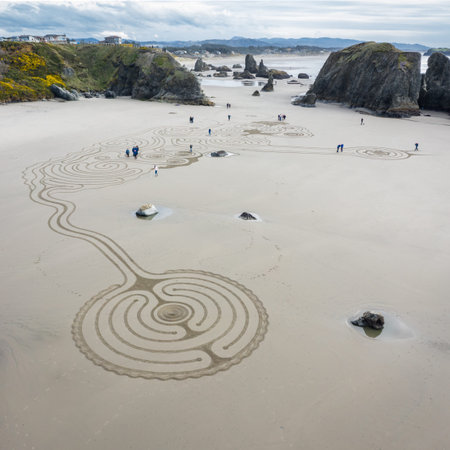Bandon by the Sea, Oregon / USA - March 08 2020: Team of Circles in the Sand drawing a walkable...