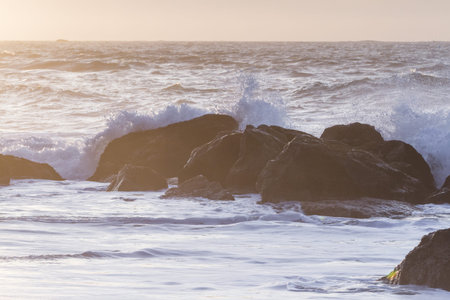Rocky shoreline in Nesika Beach, Oregon late in the afternoon with the sun approaching the horizon...