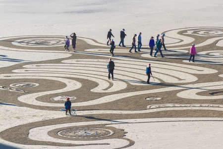 Bandon by the Sea, Oregon / USA - February 20 2020: People walking on the labyrinth made by the team of Circles in the Sand  in the flat sandy beach of Face Rock State Parkのeditorial素材