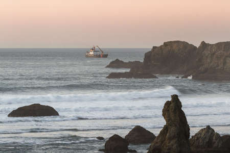 Bandon by the Sea, Oregon / USA - February 20 2020: US Coast Guard ship dredging in the southern Oregon coastのeditorial素材