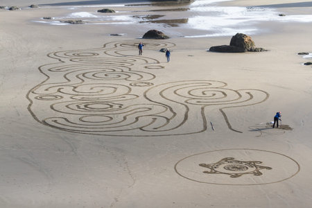 Bandon by the Sea, Oregon / USA - February 21 2020: The team of Circles in the Sand drawing a...