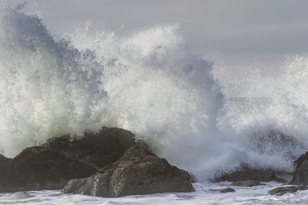 Rocky shoreline in Nesika Beach, Oregon late in the afternoon with the sun approaching the horizon...