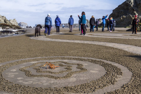 Bandon by the Sea, Oregon / USA - March 13 2020: People walking the labyrinth on the beach created...