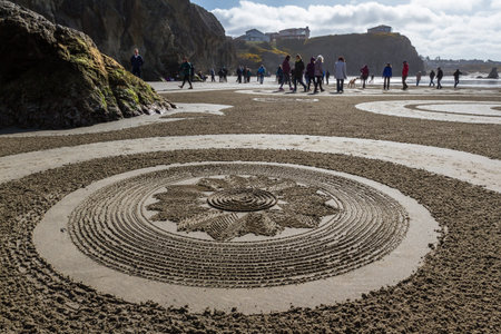 Bandon by the Sea, Oregon / USA - March 13 2020: People walking the labyrinth on the beach created...