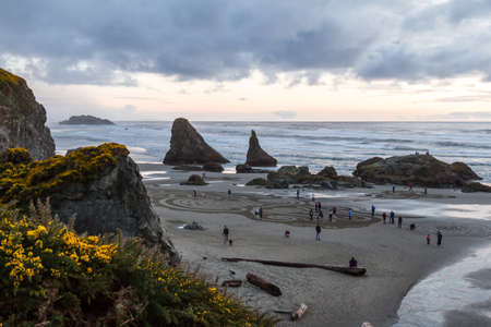 Bandon by the Sea, Oregon / USA - March 13 2020: Elevated view of a beautiful labyrinth on the beach created by the team of Circles in the Sand with people walking thru giving it scaleのeditorial素材