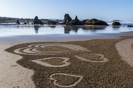 Bandon by the Sea, Oregon / USA - March 13 2020: Elevated view of a beautiful labyrinth on the beach created by the team of Circles in the Sand with people walking thru giving it scaleのeditorial素材