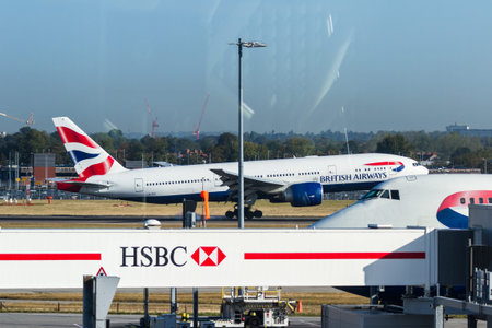 Heathrow, London UK - September 19 2019: British Airways plane landing viewed from the Lounge.