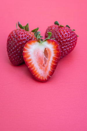 Fresh ripe juicy strawberries isolated on a red backgroundの写真素材