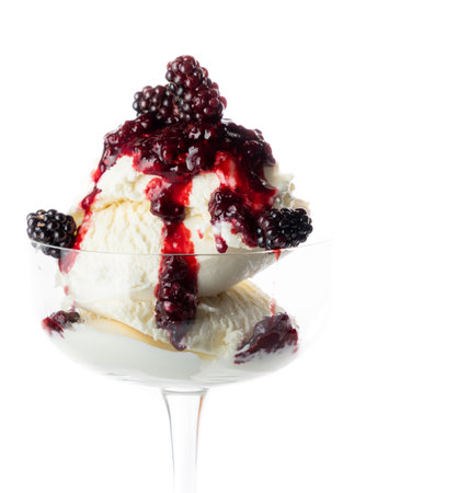 Fresh wild berries on top of vanilla ice cream isolated on a white background.の写真素材