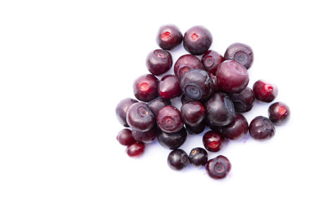 close up of a heap of large fresh huckleberries isolated on a white background