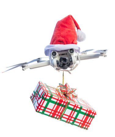 Drone concept wearing a santa hat and holding a wrapped gift out for delivery isolated on a white background.の写真素材
