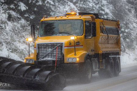 Snow plow driving on highway 101 in southern Oregon getting ready for a rare snow stormの写真素材
