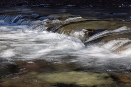 Clear beautiful river with fresh glacier melt water in Glacier National Park, Montanaの写真素材