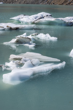 Icebergs floating in Upper Grinnell Lake in Glacier National Park montana on a beautiful afternoon.