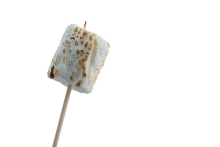 Close up of a toasted marshmallow on a stick isolated on a white backgroundの写真素材