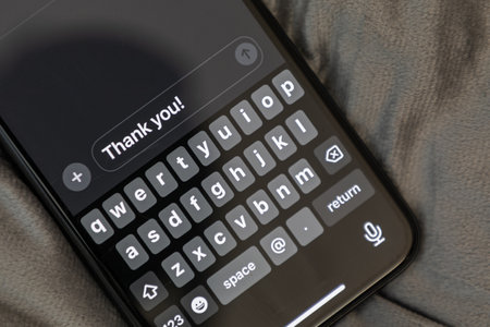 A phone with a keyboard on it that says "thank you" on it ready to send a messageの写真素材